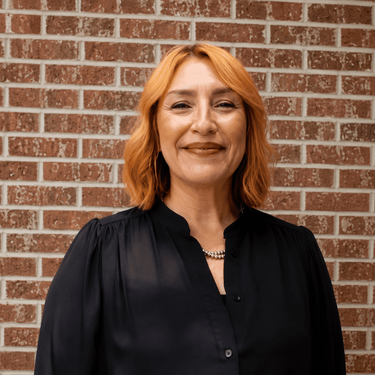 Portrait of Cara, a professional stylist at 209 Salon and Extensions Studio, showcasing their expertise and style.