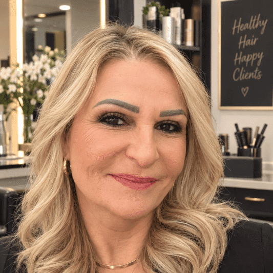 Portrait of Enas, a professional stylist at 209 Salon and Extensions Studio, showcasing their expertise and style.