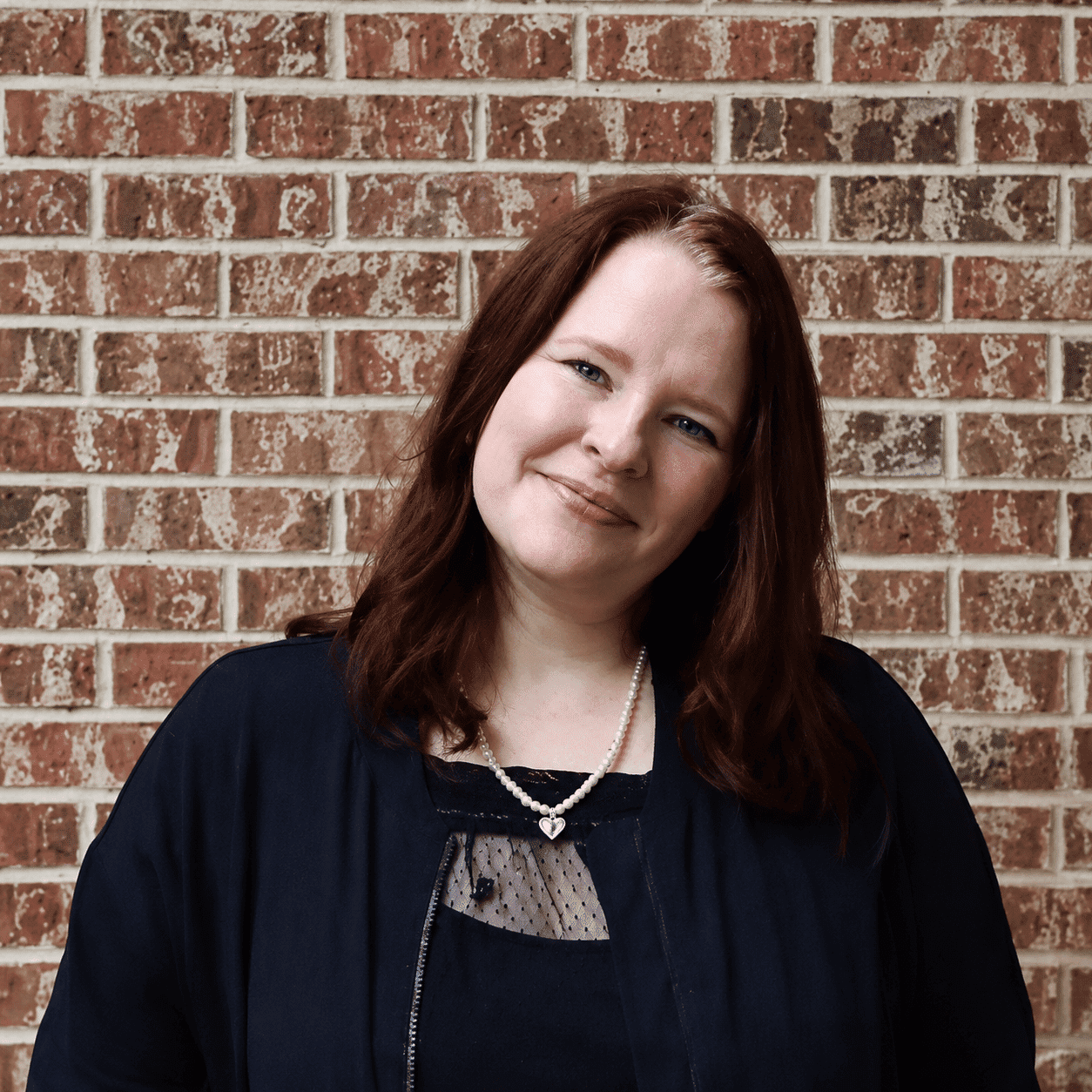 Portrait of Katelin, a professional stylist at 209 Salon and Extensions Studio, showcasing their expertise and style.