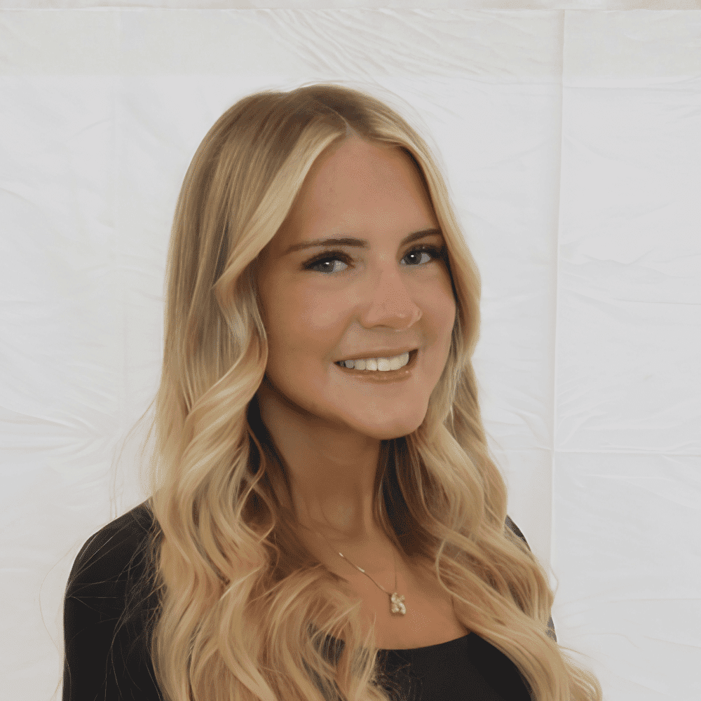 Portrait of Korinne, a professional stylist at 209 Salon and Extensions Studio, showcasing their expertise and style.