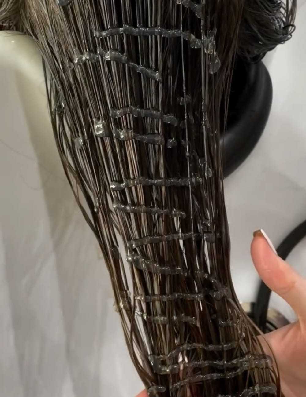 Wet hair styled in a creative lattice pattern, with strands carefully woven and textured.